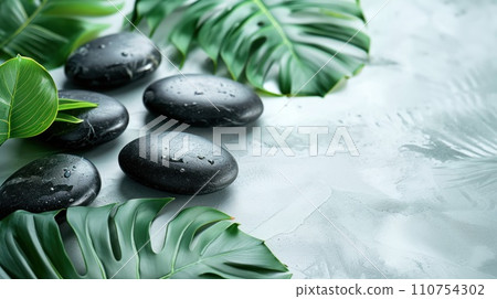 massage leaves and black stones on a white background 110754302