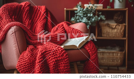 chair with red blanket and book chair with red blanket and book 110754433