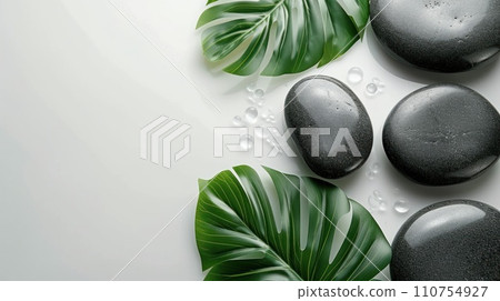 relax with stones on white background with tropical leaf relax with stones on white background with tropical leaf 110754927
