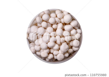 Small white edible beech mushrooms with salt and spices on a plain background 110755980