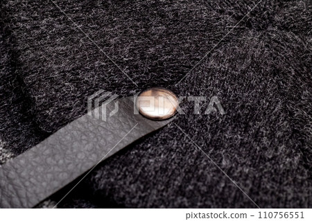 Button and strap on black knitted clothes 110756551