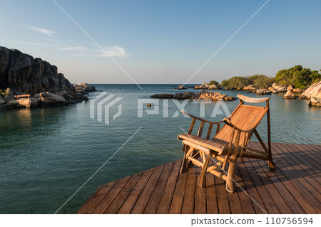 Deck chair at patio by sea in morning, Ko Man Klang, Rayong 110756594