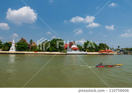 motor wooden boat sailing pass temple on Chao Phraya river 110756606