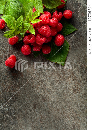 Fresh raspberries with leaves. Fresh raspberries with leaves. 110756744