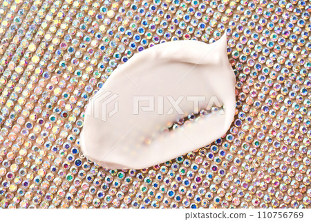A savory smear of white cream on a background of rhinestones. A savory smear of white cream on a background of rhinestones. 110756769