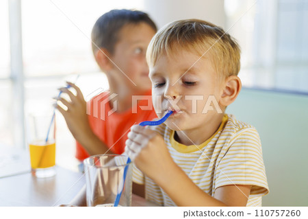 Young Boys Enjoying Fresh Juice at Home Young Boys Enjoying Fresh Juice at Home 110757260