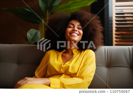 Relaxing Day: Cheerful Black Woman Lounging on Sofa Relaxing Day: Cheerful Black Woman Lounging on Sofa 110758087