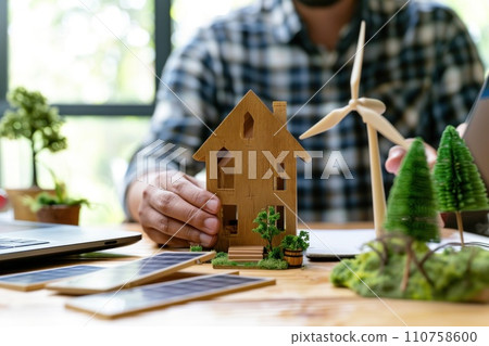 AI-generated content. Architect designer hold small wooden house symbol while thinking about home design. Generative AI 110758600
