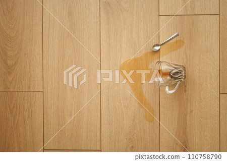 cup of coffee spilled on wooden floor cup of coffee spilled on wooden floor 110758790