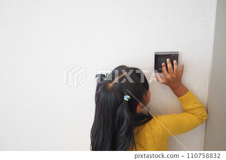 child finger turning on lighting switch with copyspace  110758832