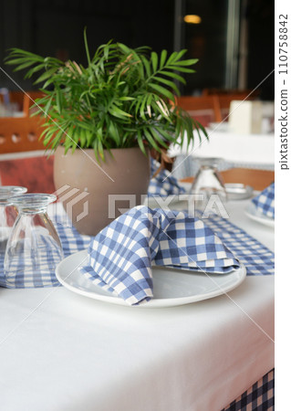served and decorated round festive table in a restaurant served and decorated round festive table in a restaurant 110758842