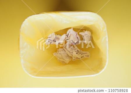 crumpled paper ball in a bin top view  crumpled paper ball in a bin top view  110758928