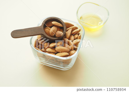 almond oils and fresh nuts on table  110758934