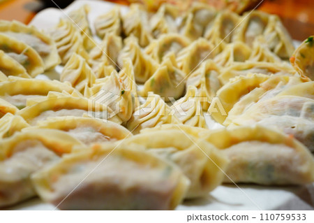 Many handmade dumplings placed on a white table Many handmade dumplings placed on a white table 110759533