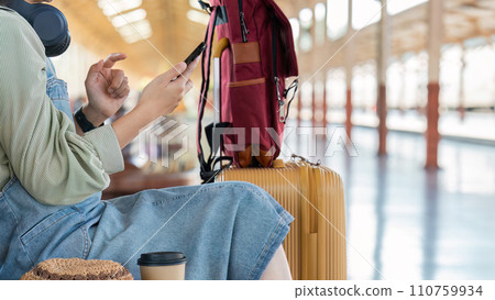 Woman using mobile phone while travel by train. travel concept 110759934