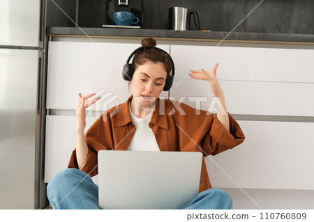Excited young woman, programmer achieves goal, triumphing, winning on laptop, sitting in headphones, dancing with hands, celebrating victory Excited young woman, programmer achieves goal, triumphing, winning on laptop, sitting in headphones, dancing with hands, celebrating victory 110760809