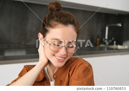 Portrait of gorgeous young woman in glasses, with happy smile, looking cute and tender, concept of modern people lifestyle 110760853
