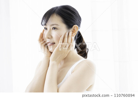 A woman in her 30s feels the moisture in her skin 110760894