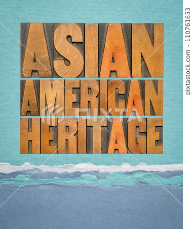 Asian American Heritage - word abstract in vintage letterpress wood type against art paper in blue tones, reminder of cultural event 110761653