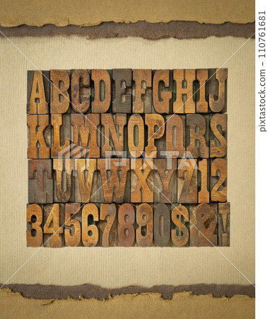 letters and numbers in vintage letterpress wood type on art paper, alphabet in French clarendon typeset 110761681