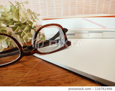 notebook and glasses on the desk 110762466