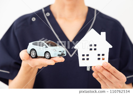 Medical workers, nurses, doctors, and care workers with house and car models Medical workers, nurses, doctors, and care workers with house and car models 110762534