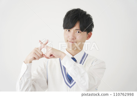 High school boy making a cross gesture, white background 110762998