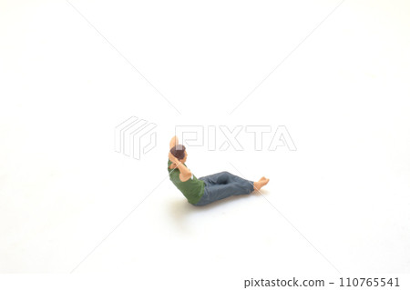 Miniature Man Relaxing with Hand on Head Isolated on White 110765541