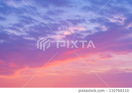 Clouds in the sky turn pale colors in the morning glow. Clouds in the sky turn pale colors in the morning glow. 110768310
