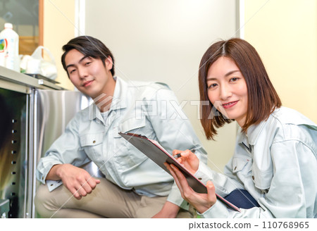 Workers checking commercial kitchen utensils 110768965