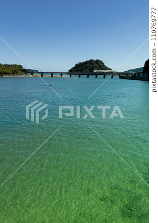Under the blue sky, the limited express train runs on the iron bridge over the Hosoda River. Under the blue sky, the limited express train runs on the iron bridge over the Hosoda River. 110769777