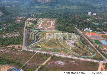 Aerial top view of garden park with lake or river in travel and environment concept. Nature landscape background in Thailand. Aerial top view of garden park with lake or river in travel and environment concept. Nature landscape background in Thailand. 110770273