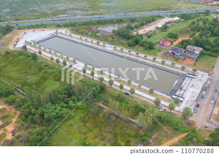 Aerial top view of arrow direction shape with garden park with green mangrove forest trees, river, pond or lake. Nature landscape background, Thailand. 110770288