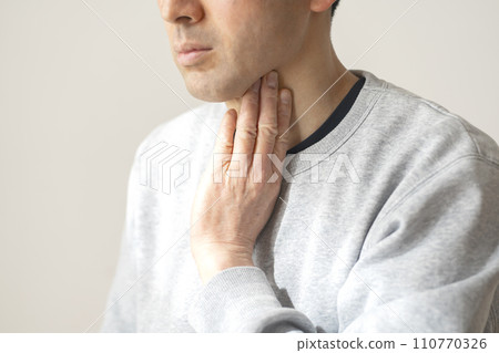 A man concerned about his throat A man concerned about his throat 110770326