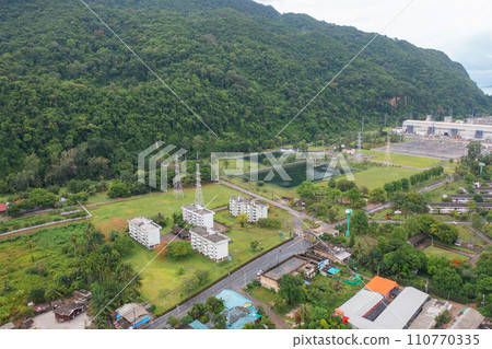 Aerial view of electricity generating, voltage poles with sea b. Power lines on utility tower and cable wires in energy electric technology, and industry. Generator pylon. Transmission and substation. 110770335