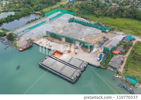 Aerial top view of concrete cement factory industry with sea. Electricity tower building in energy, transportation, logistic or environment concept. Manufacturing workshop station. 110770337