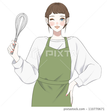 A woman in an apron holding a whisk 110770671