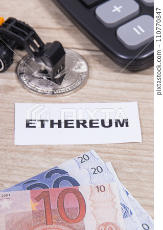 Ethereum coin, miniature excavator and euro bills. Cryptocurrency Ethereum coin, miniature excavator and euro bills. Cryptocurrency 110770847