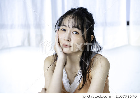 A young woman with a feminine atmosphere relaxing in casual clothes A young woman with a feminine atmosphere relaxing in casual clothes 110772570
