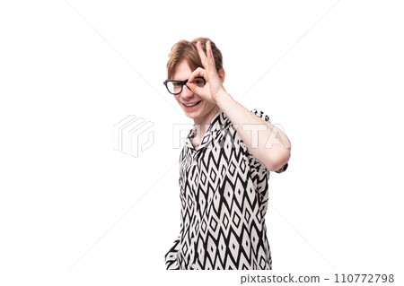 young serious handsome caucasian man with reddish golden hair in a black and white summer shirt with young serious handsome caucasian man with reddish golden hair in a black and white summer shirt with 110772798
