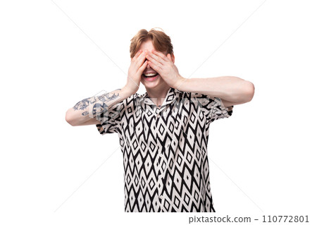 portrait of an emotional young caucasian man with red hair with a tattoo dressed in a summer black portrait of an emotional young caucasian man with red hair with a tattoo dressed in a summer black 110772801