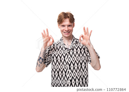 young smiling red-haired man dressed in a summer short-sleeved shirt in black and white young smiling red-haired man dressed in a summer short-sleeved shirt in black and white 110772864