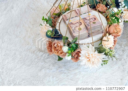 A piles of Khan Mak money in a basket for thai wedding traditions A piles of Khan Mak money in a basket for thai wedding traditions 110772907