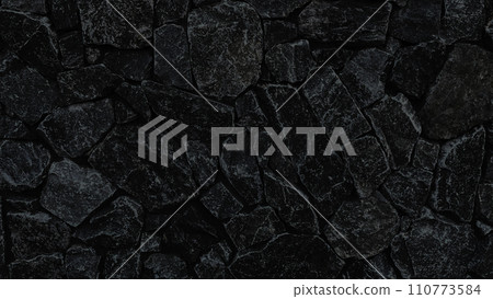 Horizontal background image of black-gray irregularly shaped masonry surface 110773584