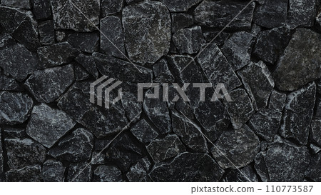 Horizontal background image of the surface of charcoal-colored irregularly shaped masonry 110773587