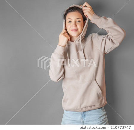 Portrait of a young pretty girl in a hoodie Portrait of a young pretty girl in a hoodie 110773747