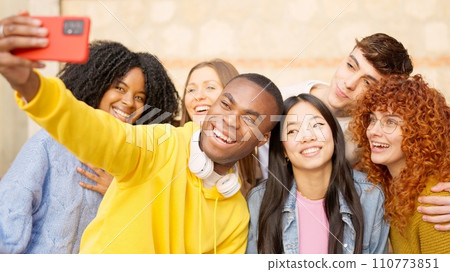 African man taking a selfie with multi-ethnic friends outdoors African man taking a selfie with multi-ethnic friends outdoors 110773851