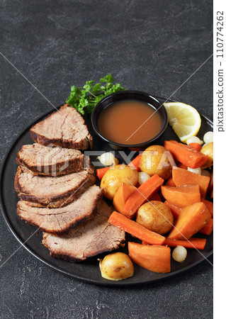 roast beef with dipping sauce and winter veggies roast beef with dipping sauce and winter veggies 110774262