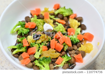 Dog food topped with vegetables, broccoli, sweet potato, carrot, liver, supplement Dog food topped with vegetables, broccoli, sweet potato, carrot, liver, supplement 110774736