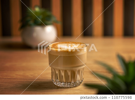 Hot creamy milk in coffee. Hot creamy milk in coffee. 110775598